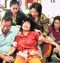 Distraught relatives of missing passengers aboard Malaysian airlines in Medan on Sunday. 