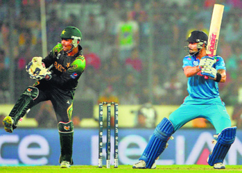 Virat Kohli (R) in action during the ICC World Twenty20 match between India and Pakistan in Dhaka on Friday. India beat Pakistan by seven wickets as Kohli scored a quickfire 36.
