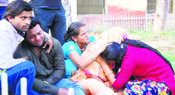 Grieving relatives of one of the students outside the civil hospital at Faridabad on Monday. Tribune photo