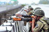 Security men on guard along the Jammu-Pathankot highway during a terror attack in Kathua district.