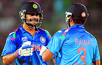 Virat Kohli (L) and Suresh Raina share a light moment during the chase as India defeated South Africa in the ICC Twenty20 World Cup semifinal in Dhaka on Friday. Kohli notched up an unbeaten 44-ball 72