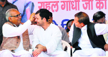 Haryana Chief Minister Bhupinder Singh Hooda cleans the tilak from Congress vice-president Rahul Gandhis forehead as party candidate from Karnal seat Dr Arvind Sharma looks on in Panipat on Sunday. 