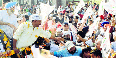 Aam Aadmi Party convener Arvind Kejriwal greets people during a road show in Amritsar on Friday