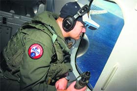 A naval aircrewman on a search mission in the Indo-Asia-Pacific region