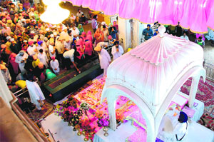 People offer prayers at Gurdwara Nada Sahib on Baisakhi in Panchkula on Monday.