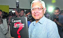 Former Coal Secretary PC Parakh poses with his book "Crusader or Conspirator" in New Delhi on Monday.