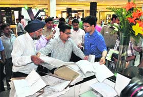 SDM Kashish Mittal (right) looks at the master plan of the Elante Mall in the Industrial Area, Chandigarh, on Saturday