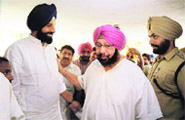 Congress Amritsar candidate Capt Amarinder Singh with Revenue Minister Bikram Singh Majithia at a polling booth in Majitha