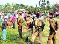 Security personnel at Narsingbari where some people were killed by militants in Baksa district of Assam on Friday