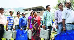 Officials leave with election material for their respective polling stations in Mandi district of Himachal Pradesh on Monday.