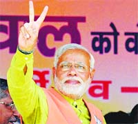 Narendra Modi shows a victory sign at a rally in Bihar