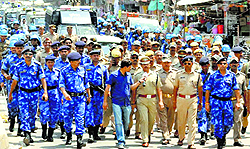 Security personnel conduct a flag march ahead of the last phase of voting in Varanasi