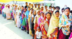 Voters queue up at a polling station in Murshidabad, West Bengal, on Monday. PTI