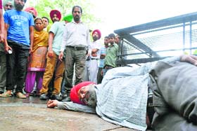 An unconscious Harbhajan Singh outside the DC’s office in Ludhiana on Monday