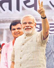 BJPs PM nominee Narendra Modi flashes a victory sign at Vadodara