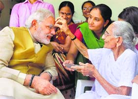 A victorious Narendra Modi seeks the blessings of his mother Hiraba at her home in Gandhinagar