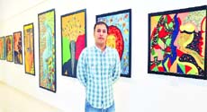 Brush up: Satvinder Kumar with his paintings Photo: Parvesh Chauhan