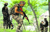 Soldiers take up positions near an encounter site in Budgam.