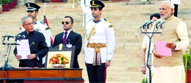 President Pranab Mukherjee administers oath of office and secrecy to Prime Minister Narendra Modi during a star-studded ceremony at Rashtrapati Bhavan in New Delhi on Monday.