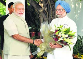 Courtesy call: Prime Minister Narendra Modi greets former Prime Minister Manmohan Singh at his residence 3 Motilal Nehru Marg, in New Delhi on Tuesday