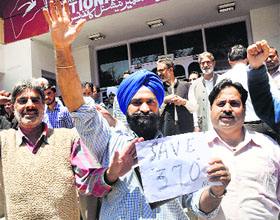 NC workers protest against the statement of Minister of State in PMO Jitendra Singh on Article 370, in Srinagar.