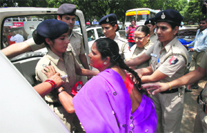 Residents of illegal dwelling units in Sector 25 being rounded up by the police near the Sector 16 stadium where they protested against the move to demolish their colony by the UT Estate Office.