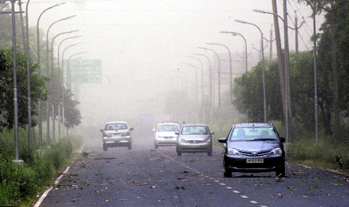 Vehicles caught in a dust storm at the Industrial Area , Phase VIII, Mohali, on Friday.