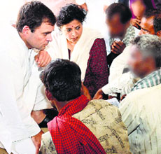 Congress V-P Rahul Gandhi with the family members of the two victims at Katra Shahadatganj village in Badaun district.