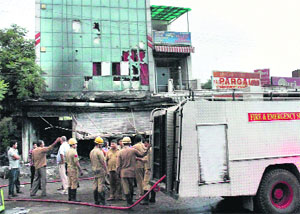 Fire-fighters near the hotel in Jammu on Saturday.