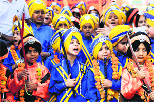 Young children as ‘The Panj Pyaras’ during a nagar kirtan organised to commemorate the martyrdom of Guru Arjan Dev.