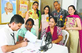 A doctor examines a patient at a heart check-up camp at Jain Eye Hospital, Civil Lines, in Ludhiana