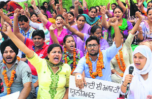 Inclusive education resource teachers sit on a hunger strike in support of their demands, including pay-scales on a par with government teachers and summer and winter vacations, at Phase VIII in Mohali on Monday.
