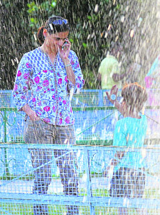 A woman and her child enjoy an evening near the fountains at the Rose Garden in Sector 16, Chandigarh.