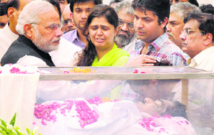Prime Minister Narendra Modi consoles the family of Rural Development Minister Gopinath Munde at the BJP headquarters in New Delhi on Tuesday. 