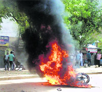 A motorcycle set on fire at Mewats Tauru village during communal violence.