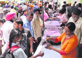 Sweetened water being offered to residents outside the GMCH, Sector 16, on Tuesday