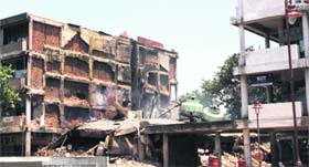 Smoke billows out of the debris of the collapsed building in Sector 17, Chandigarh, on Tuesday