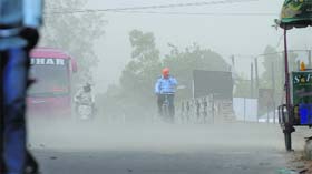 Weather Woes: Commuters have a tough time during a dust storm in Ludhiana on Wednesday