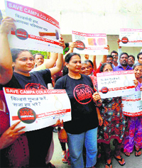People show placards in support of Campa Cola residents in Mumbai on Friday