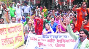 Members of the 7654 Joint Front Teachers Union, Punjab, stage a protest at Phase VIII in Mohali on Tuesday.