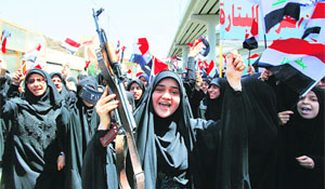 Shi'ite women raise slogans in favour of the Iraqi army in Najaf, south of Baghdad, on Tuesday. Iraq's Shi'ite rulers defied Western calls to reach out to Sunnis.
