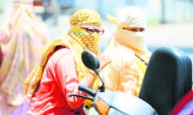 Girls protect themselves from the sun in Ludhiana.