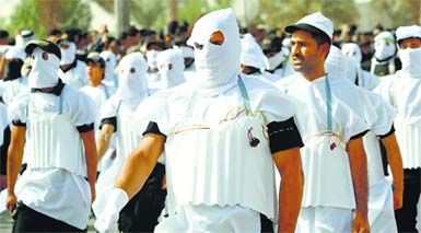 Shia fighters wearing explosive belts march in the central Iraqi city of Karbala on Saturday. The fighters also held parades in Baghdad and south Iraq in a show of strength against Sunni rebels. 