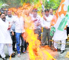Congress activists raise slogans during a protest against rail fare hike, in New Delhi on Saturday. 