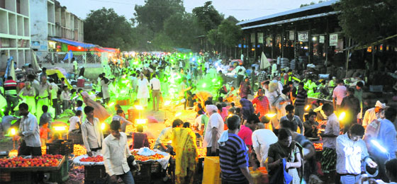 Vendors encroach upon the road in the Grain Market, Sector 26, in the evening