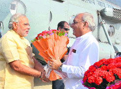 Haryana CM Bhupinder Singh Hooda greets PM Narendra Modi at Surajkund in Faridabad district on Saturday.