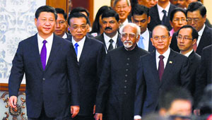 Vice-President Hamid Ansari (C) arrives at the Great Hall of the people in Beijing on Saturday.