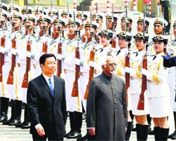 Vice-President Hamid Ansari and his Chinese counterpart Li Yuanchao inspect a guard of honour in Beijing on Monday.