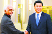 Chinese President Xi Jinping (R) greets Vice-President Hamid Ansari at the Great Hall of the People in Beijing. AFP 