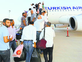 Turkish truck drivers who were released by militants board a  plane at an airport in Erbil, Iraq.